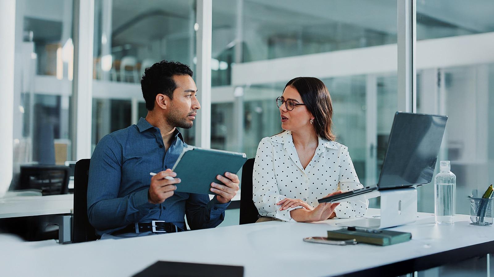 An illustrative scene of two professionals in a thoughtful discussion
